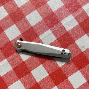 Stylish Silver Pocket Knife with Orange Accent